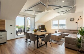 A modern living space with a dining area, a sofa, and a TV. - Nice apartment in Vrsi with swimming pool (Vrsi)