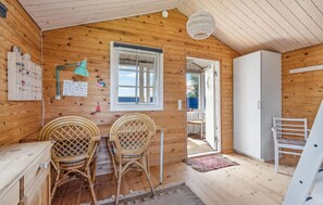 Cozy room with a dining area, white cabinet, and sloped ceiling.