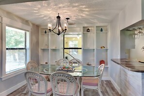 Enjoy meals in this stylish dining area with a glass-top table and comfortable seating.