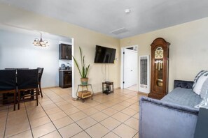 Cozy living space with a dining area, seating area, and television.