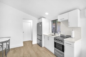 Enjoy cooking in this well-equipped kitchen with a refrigerator, oven, and stove.