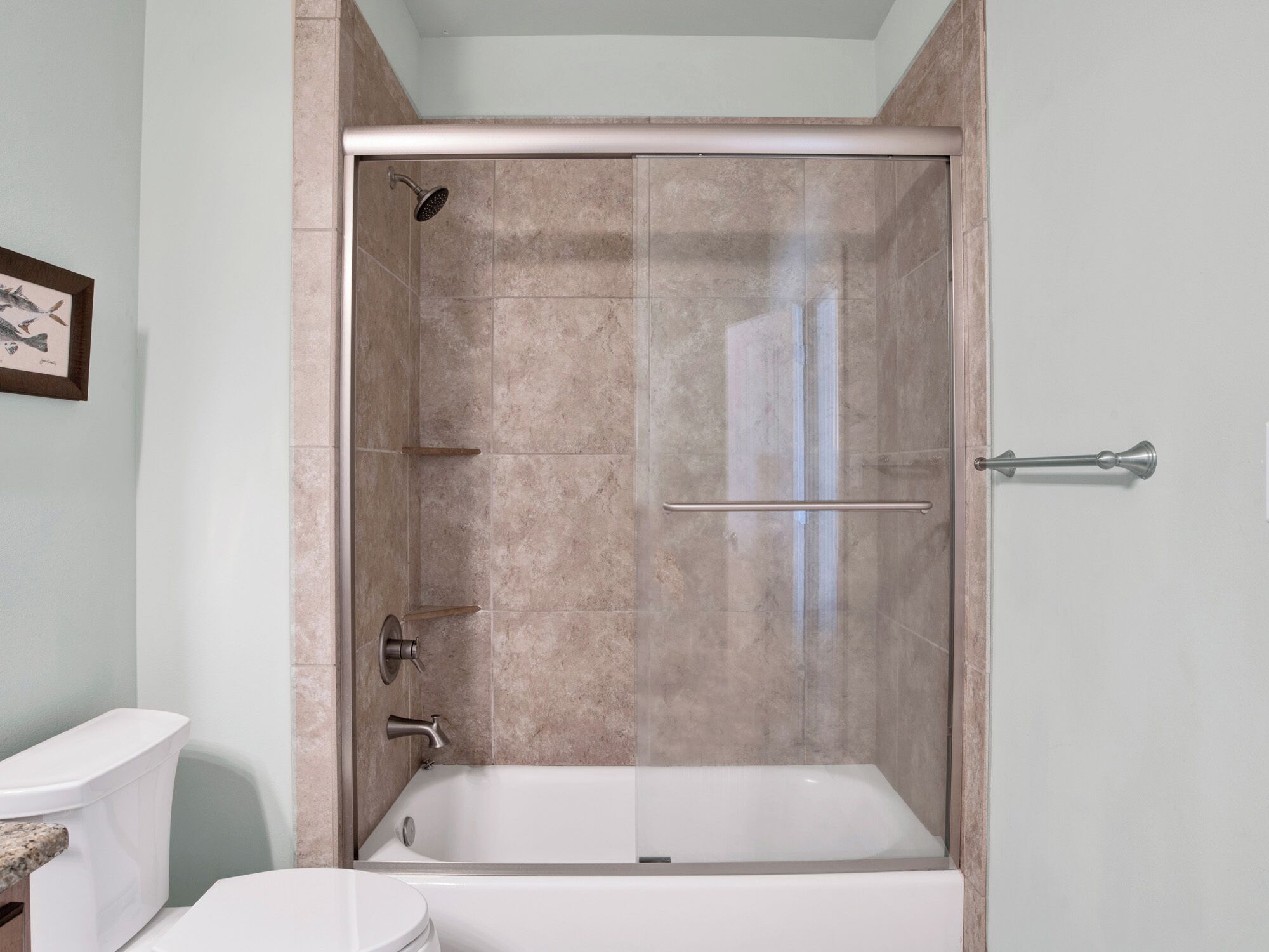 A bathroom with a shower enclosure, a bathtub, and a toilet.