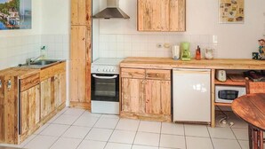 A kitchen with wooden cabinets, a stove, a refrigerator, and a sink. - Awesome home in Chalabre with WiFi (Chalabre)