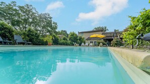 A swimming pool with lounge chairs and a yellow umbrella. - Awesome home in Chalabre with WiFi (Chalabre)