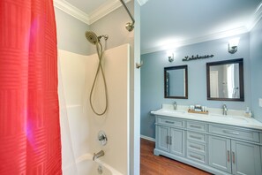 A bathroom with a shower, a vanity with a mirror, and a sign that reads "Lakehouse". - Guntersville Lake House: Boat Ramp Access! (Scottsboro)