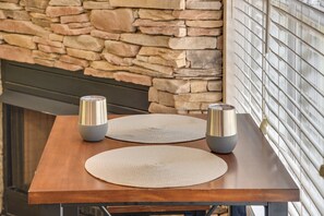 A wooden table with two metallic candle holders and two woven placemats. - Guntersville Lake House: Boat Ramp Access! (Scottsboro)