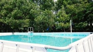 A swimming pool with a white pool ladder and a white safety fence. - Hotel Laguna (Ureki)