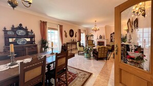 A traditional living room with a fireplace, wooden furniture, and decorative items. - Lagos Typical House by Homing (Lagos)