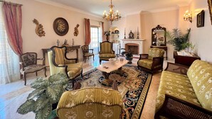 A traditional living room with a fireplace, ornate furniture, and a chandelier. - Lagos Typical House by Homing (Lagos)
