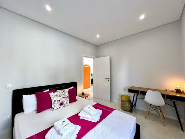 A modern hotel room with a large bed, a desk, and a chair. - Praia DA Rocha Modern by Homing (Portimão)