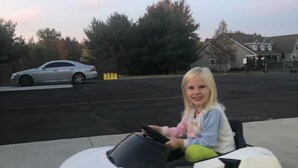 A child driving a white toy car on a concrete surface. - The Calico Cottage - Fire Pit - Hot Tub (Lewis Center)