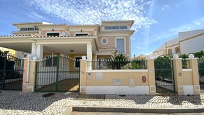 A two-story house with a gated entrance, a covered porch, and a tiled driveway. - Pêra Amazing Villa With Pool by Homing (Silves)