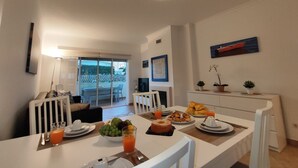 A dining area with a table set for breakfast, including fruits, pastries, and orange juice. - Albufeira Valley 2 With Pool by Homing (Albufeira)