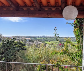 A balcony with a view of a cityscape, a white paper lantern, and lush greenery. - Pêra Vintage Villa With Pool by Homing (Silves)