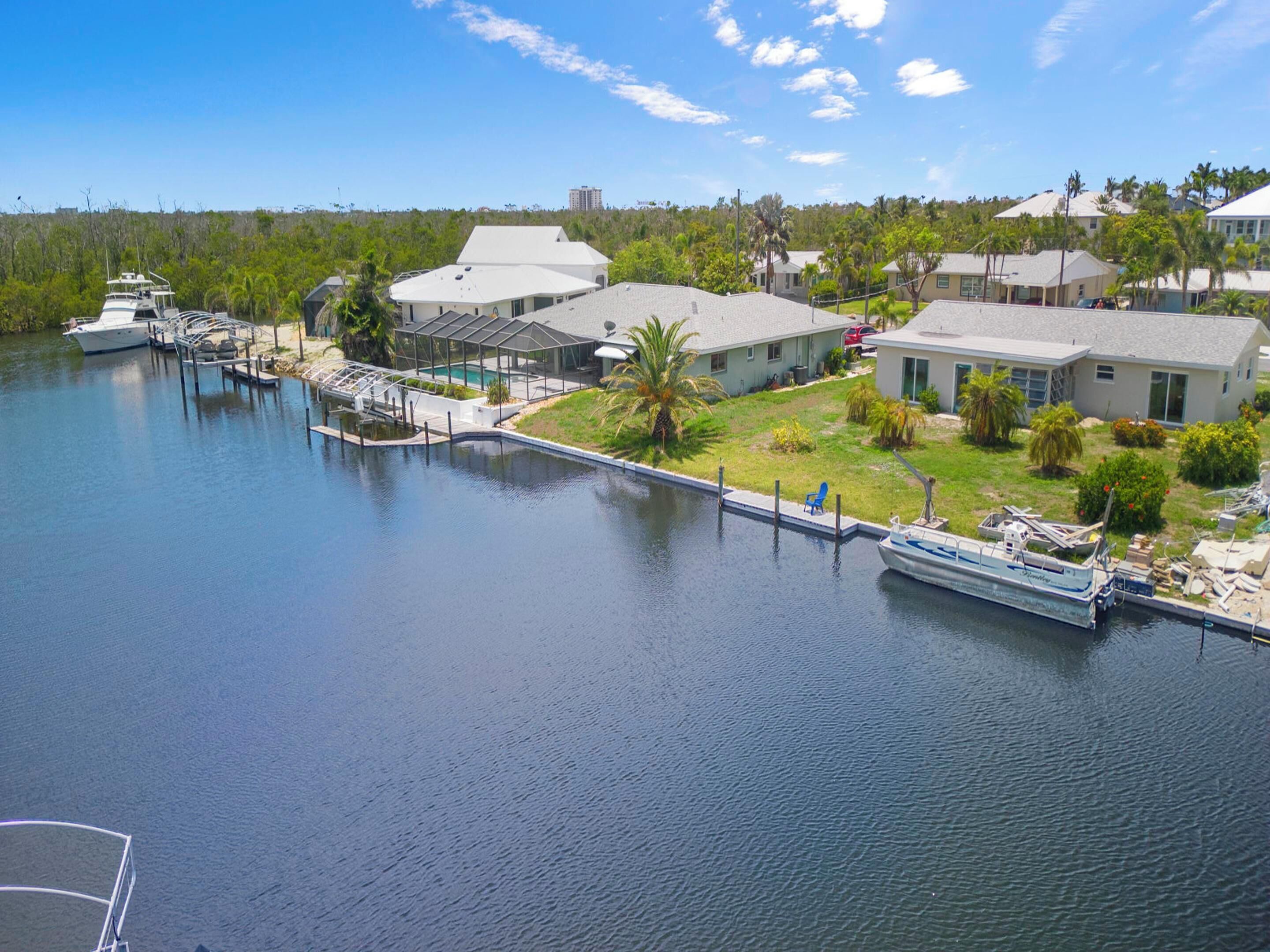 A waterfront property with a dock, a house, and a boat.
