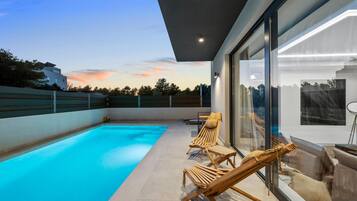 Relax by the pool surrounded by a clear view of the sky and lush landscape.