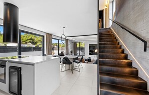 Enjoy meals in the spacious kitchen and dining area with a large island and long table.