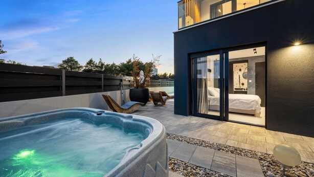 A modern outdoor hot tub area with a pool, lounge chairs, and a glass-enclosed bedroom. - Pet friendly home in Vodice with sauna (Vodice)