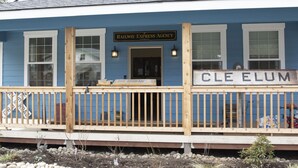 A blue building with a sign reading "Railway Express Agency" and "CLE ELUM".