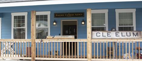 A blue building with a sign reading "Railway Express Agency" and "CLE ELUM".