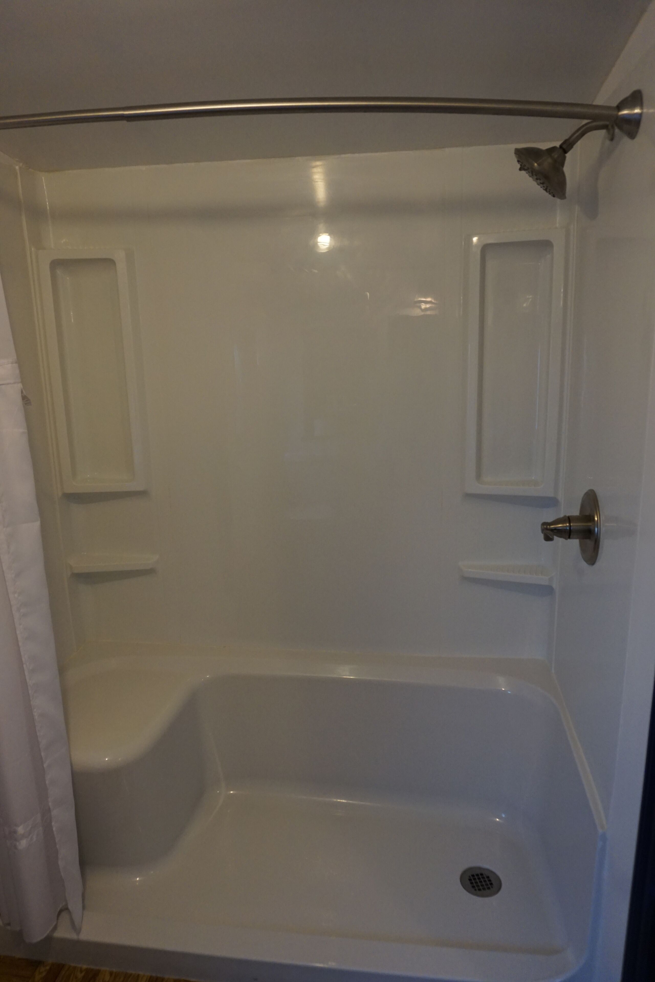 A bathroom with a bathtub, a shower, and a toilet.