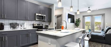 Fridge, coffee/tea maker, cookware/dishes/utensils, dining tables