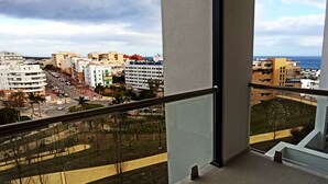 A balcony with a view of a cityscape, including buildings and a road. - Beautiful 2-Bed Apartment in Estepona Port (Estepona)