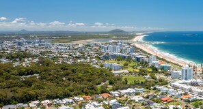 An aerial view of a coastal city with dense residential areas, beachfront properties, and high-rise buildings. - WINDARRA- ALEX HEADLAND FAMILY HOLIDAY (Alexandra Headland)