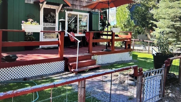A wooden building with a porch, a sign reading "The Dobbins," and a red umbrella. - 2 bedroom cabin in mineral (Mineral)