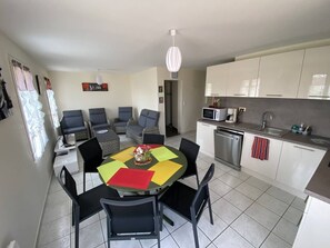 A compact living space with a dining area, kitchen, and seating arrangement.
