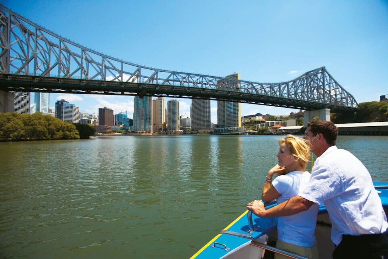 Un río con un puente y edificios de la ciudad al fondo.