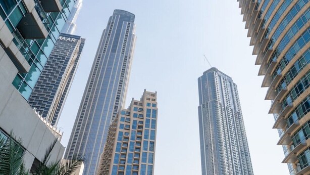 A view of tall, modern high-rise buildings with reflective glass facades and a clear sky. - 1 Bed Downtown| Walk to Dubai Mall & Burj Khalifa (Downtown Dubai)