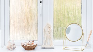 A bathroom with two large windows, a white sink, and a decorative mirror. - Quiet Peaceful Location (Bristol)