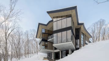 Experience the unique architecture of this multi-level building, featuring a prominent overhanging roof and spacious balconies.