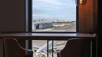 A view from a window overlooking an airport with airplanes on the tarmac.