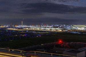 An airport at night with illuminated runways and buildings.