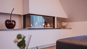 A modern kitchen with a built-in stove, a decorative apple-shaped vase, and a small potted plant. - Modern apartment in the center of Nieuwpoort (Nieuwpoort)