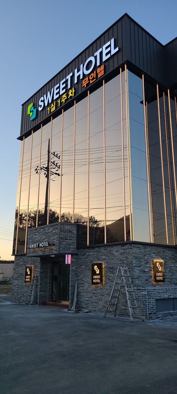 A modern building with a sign reading "Sweet Hotel" and Korean text. - SWEET HOTEL (Changnyeong)