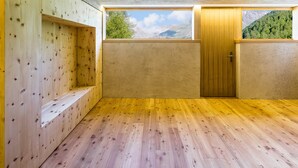 A room with wooden walls, a wooden door, and a window with a mountain view. - Apartment 'Josephus - Domicilium I' with Mountain View, Shared Terrace and Wi-Fi (Madonna di Senales)