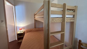 A bunk bed in a room with a small desk and a lamp. - Cozy 2-Room Apartment by the Beach with Terrace and Parking - Sleeps 4 (Saint-Jean-de-Monts)