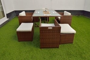 Relax in this serene space with a central table and four comfortable chairs.