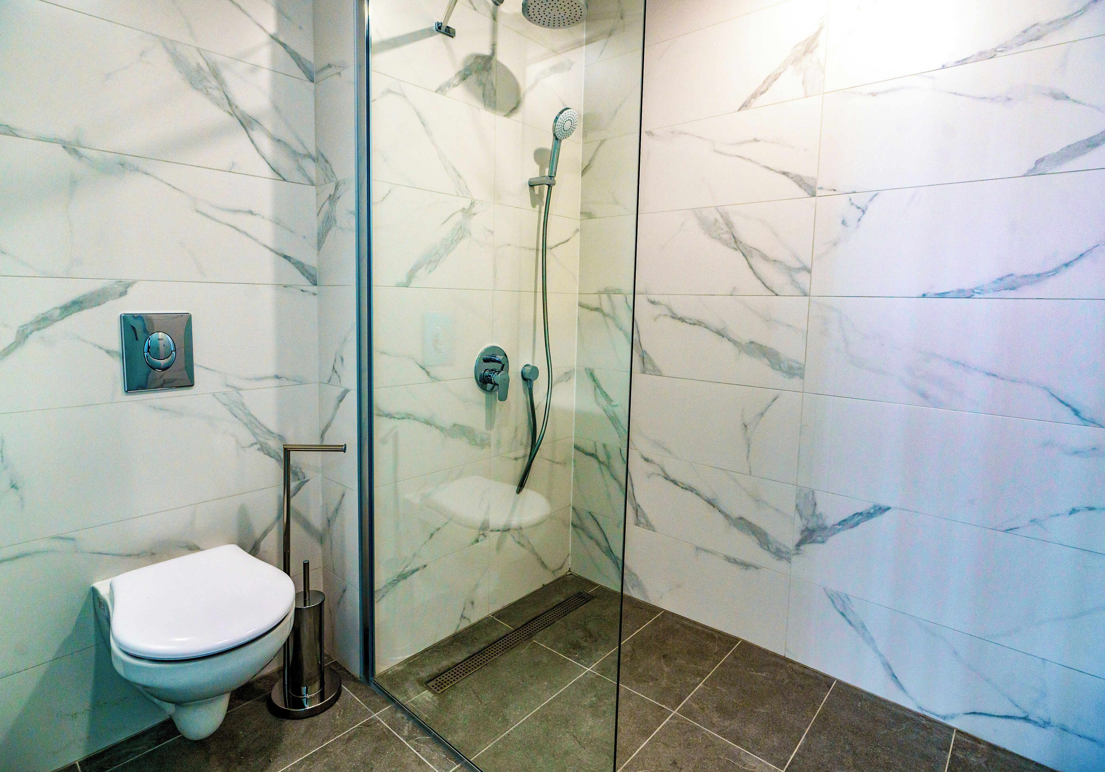 executive suite | bathroom | shower, rainfall showerhead, hair dryer, slippers