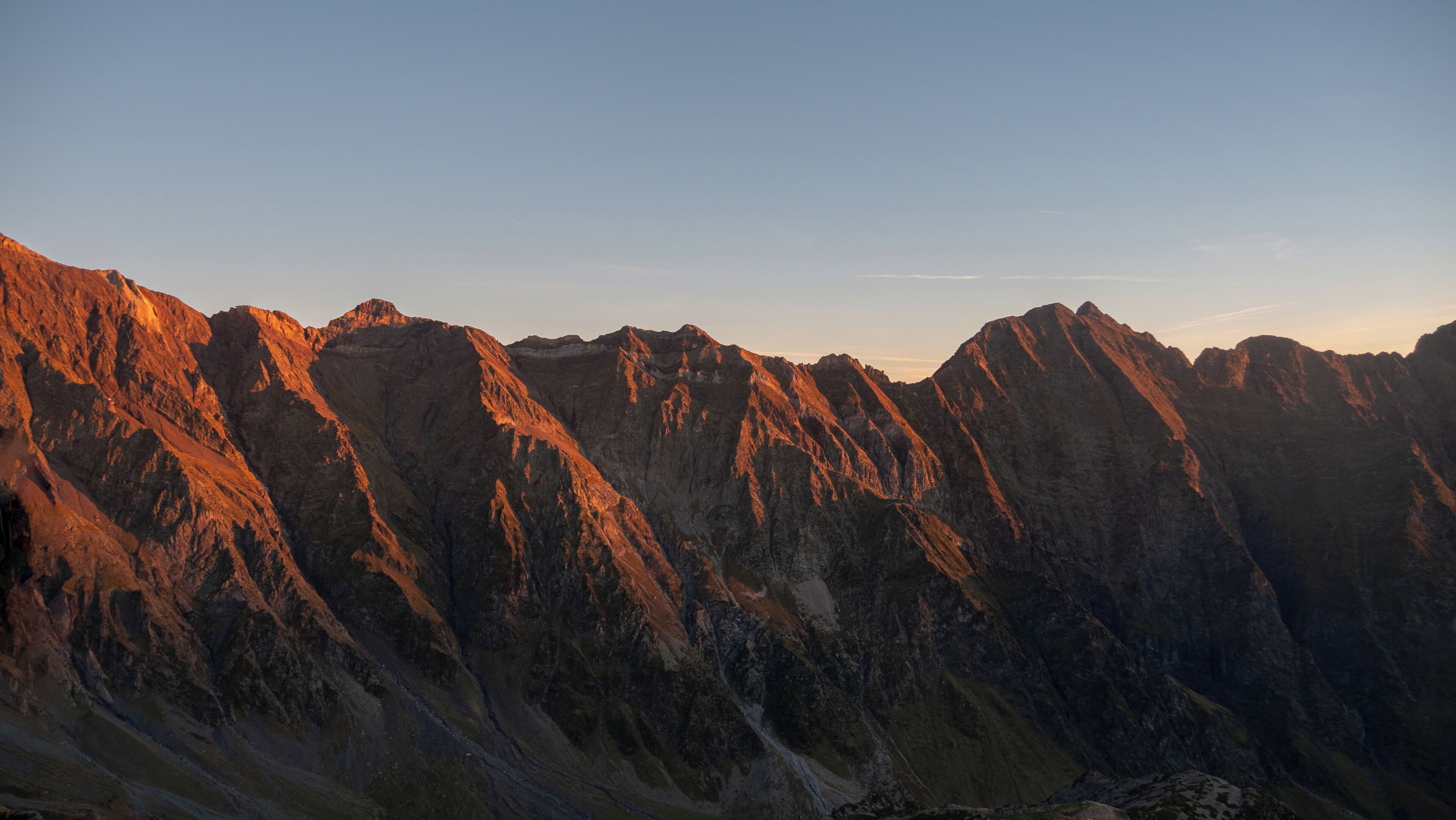 A mountainous landscape with rugged terrain and clear skies.