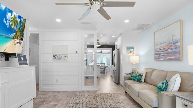 A modern kitchen with white cabinetry, a built-in oven, and a refrigerator. - Surf Drive Paradise – Oceanview Pool Home Just Steps from the Beach (St. Augustine Beach)