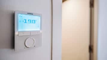 A Siemens digital thermostat mounted on a wall, displaying a temperature of 19.0°C.