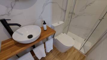 Ein Badezimmer mit Waschbecken, Toilette und Dusche.