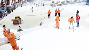 A ski resort with people skiing and snowboarding, a ski lift, and a snow-covered landscape. - Transpark Juanda Bekasi by 21 Room (Bekasi)