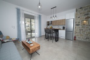 Enjoy a comfortable stay in this apartment with a spacious living area, kitchen, and dining space, plus a balcony with a sliding glass door.