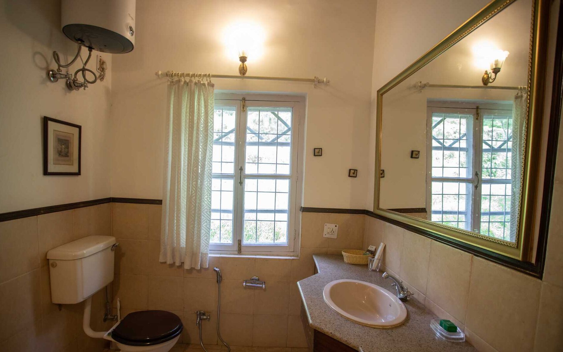 A bathroom with a toilet, sink, shower, and a large mirror.
