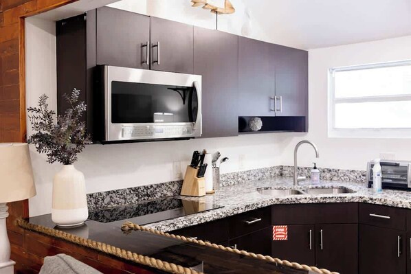 Fridge, microwave, coffee/tea maker, cookware/dishes/utensils